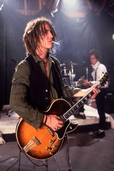 a man playing an electric guitar on stage