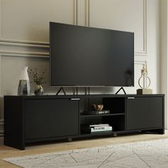 a flat screen tv sitting on top of a black entertainment center