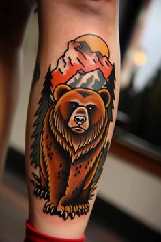 a brown bear with mountains and trees on it's back leg, done in black ink