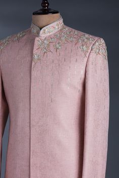 a pink suit with white flowers on it