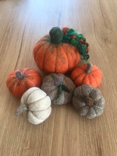 several small pumpkins on a wooden table