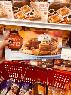 a person is holding up a card that says pumpkin waffles in front of them