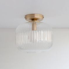 a close up of a light fixture on a ceiling with white walls in the background