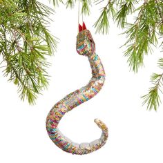 an ornament shaped like a snake hanging from a tree