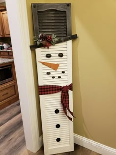 a snowman made out of an old shutter