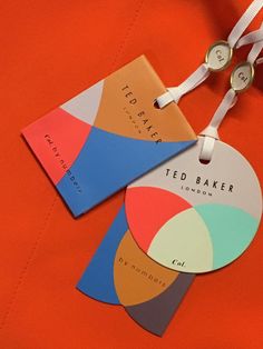 two tags are attached to an orange piece of clothing that has been designed by ted baker