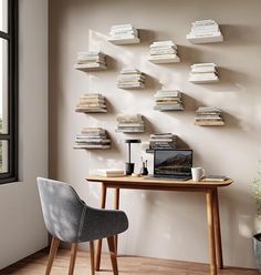 a desk with a laptop and some books on the wall next to it, in front of a window