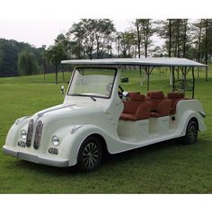 an old fashioned golf cart is parked in the grass