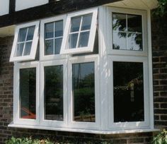 an image of a white window on the side of a house that is being used as a sunroom