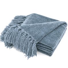 two blue towels folded on top of each other with tassels and fringe ends