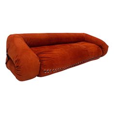 an orange reclining couch with studded trims on the arms and back, against a white background