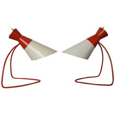 two red and white lamps sitting next to each other