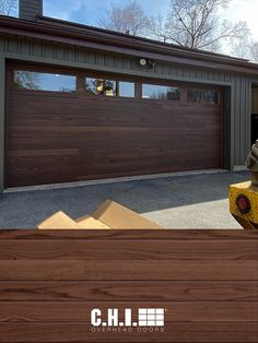 a brown garage door is open in front of a house with a fire hydrant