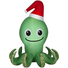 an inflatable green octopus with a santa's hat on it's head