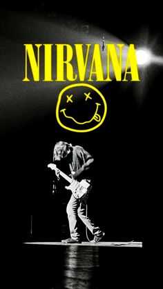 nirvana on stage with the words nirvana in yellow overlaying him and his guitar