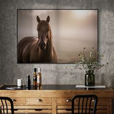 a brown horse standing next to a wooden table