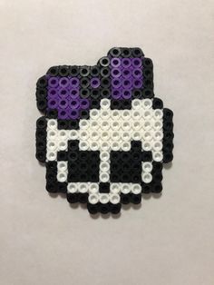 a black and white cat with purple eyes is made out of legos on a table