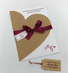 a heart shaped card with a tag attached to it