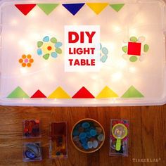 the diy light table is set up with buttons and magnets