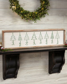 a wooden sign sitting on top of a shelf next to a wreath and christmas decorations