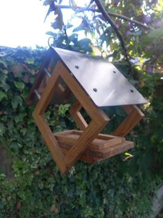 a bird feeder hanging from a tree branch