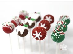 christmas cake pops on a white plate with red and green frosting, decorated with snowflakes