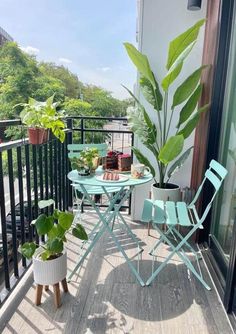 a balcony with chairs, table and potted plants