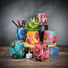 a group of vases sitting on top of a wooden table