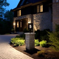 a house that is lit up at night with the number 5 on it's front door