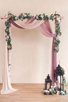 a wedding arch decorated with flowers and greenery