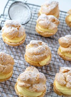 powdered sugar covered pastries on a cooling rack