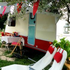 an old camper has been decorated with red and white decorations for the party guests