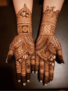 two hands with henna designs on them