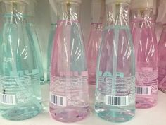 several empty water bottles lined up on a shelf