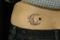 a woman's stomach with a crescent and star tattoo on her left side ribcage