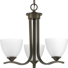 three light chandelier with white glass shades on the top and bottom lights in an antique bronze finish