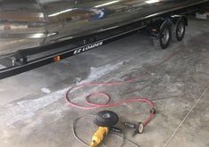 a car being worked on by a man with a hose attached to the back of it