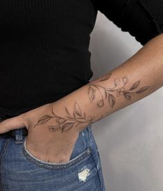 a woman's arm with a flower tattoo on the left side of her body