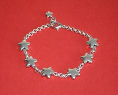 a simple bracelet made by thick silver plated Zamak connected by five stars or Pentagrams, closed by lobster closure. Adjustable size design. Please measure your wrist's size correctly, we will adjust the bracelet size based on your wrist size. Style: vintage , unique , special.... Net weight: less than 50g Package: simple package. Silver Star-shaped Bracelet With Adjustable Chain, Star-shaped Metal Bracelets As Gifts, Silver Chain Bracelet With Star Charm As Gift, Silver Adjustable Chain Bracelet With Star Charm, Adjustable Silver Chain Bracelet With Star Charm, Silver Star Bracelets For Gifts, Adjustable Silver Star-shaped Chain Bracelet, Silver Star-shaped Adjustable Chain Bracelet, Silver Star Bracelets For Gift