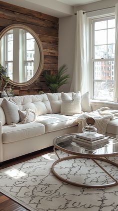 a living room filled with furniture and a large round mirror on the wall above it