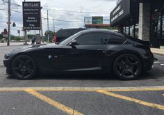 a black sports car parked in front of a building