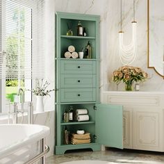 a bathroom with a sink, toilet and green cabinet in the corner by the bathtub