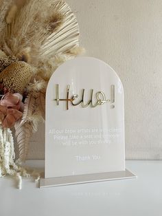 a white plaque with the word hugs written on it next to a bouquet of flowers