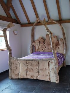 a bed made out of logs in a room