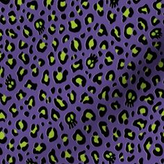 an animal print fabric with green and black skulls on purple, the background is very dark