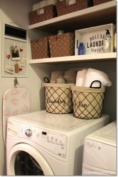 a washer and dryer in a laundry room with baskets on the shelves above