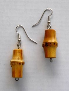 the earrings are made out of wood and metal