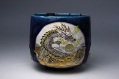 a blue and white vase with a dragon on it