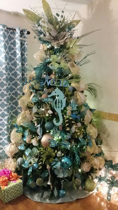 a decorated christmas tree with blue and green ornaments