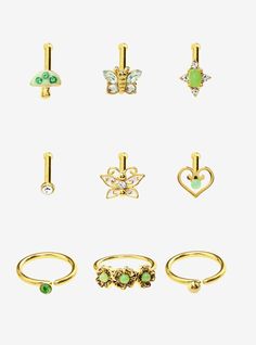 six pairs of gold rings with different designs and colors on each one, including an emerald green